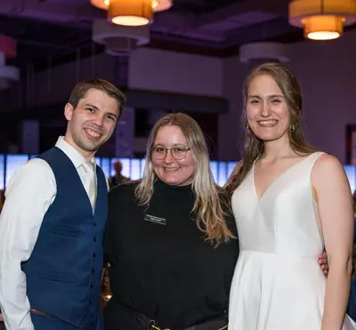 Josie alongside a newly married bride and groom